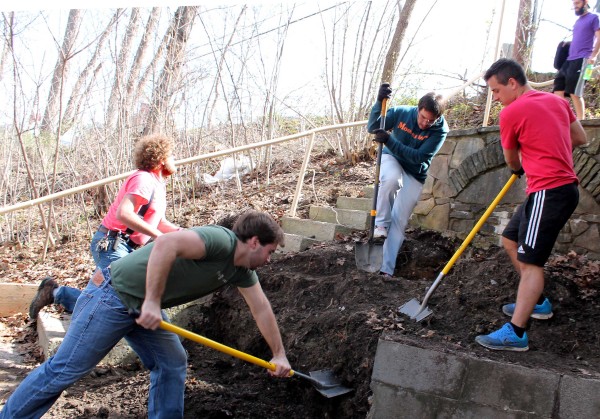 Davis & Elkins College students went to work this week helping with repairs to The Icehouse. Shoveling soil from the base of the building in preparation for drain installation are, clockwise from left, junior Chris Scholz of Bel Air, Md.; junior Alex Cheuvront of Parkersburg, W.Va.; junior Trevor Wratchford of Moorefield, W.Va.; senior Guilherme Hubsch of Sao Paulo, Brazil; and senior Oliver Bienias of Appenweier, Germany. Volunteers are welcome to join the effort. 