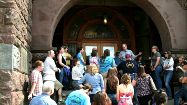 AFHA AmeriCorps members listen to Barbour County Circuit Clerk Gerald M. Fogg explaining some community history and information about the courthouse.