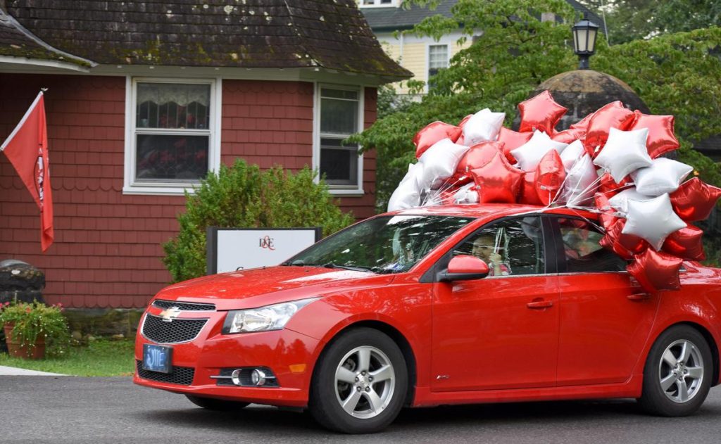 Photo Caption: Davis & Elkins College resident assistant Meaghan Eyler delivers red and white balloons that served as markers to event locations for Orientation Weekend. 