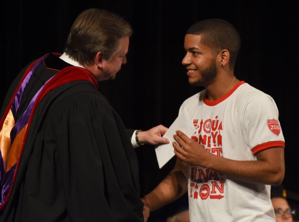 Photo Caption: Davis & Elkins College President Chris Wood hands student Christian Ortiz an envelope containing a blank sheet of stationary. Wood provided the materials for each new student’s first homework assignment – writing a letter addressed to their future selves. Students were asked to describe what they were feeling on their first day at D&E and what they hope to achieve in their college career and in life. The letters will be given to Wood and returned to students on their graduation day.