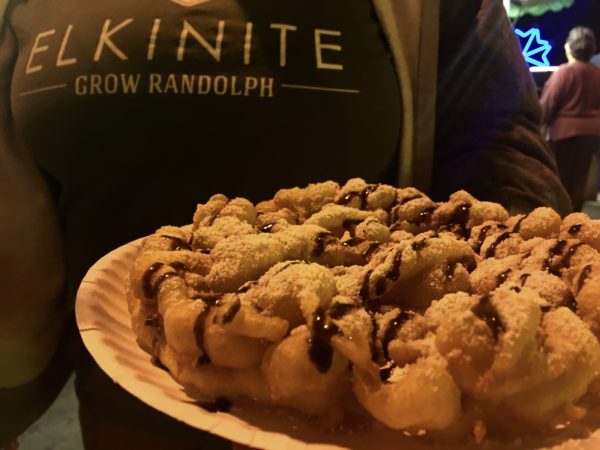 Filling funnel cake covered in a perfect chocolate drizzle